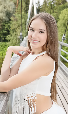 Sasha Quinn Smiling Playfully As Her Short Skirt Flips Up To Reveal She’s Not Wearing Panties